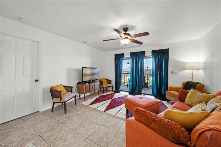 Tiled living room featuring ceiling fan
