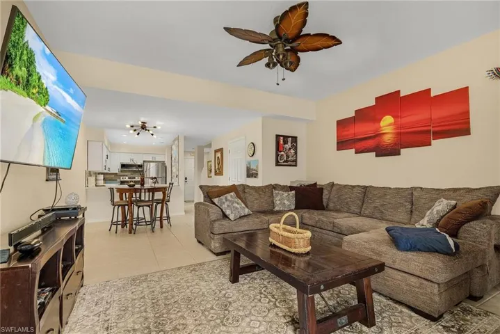 Tiled living room featuring ceiling fan