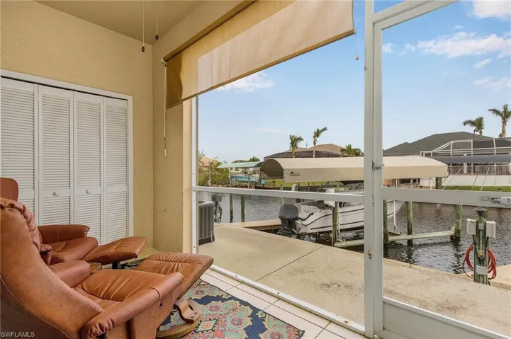 Sunroom / solarium featuring a water view