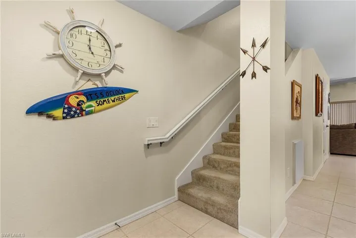 Stairs with light tile patterned floors