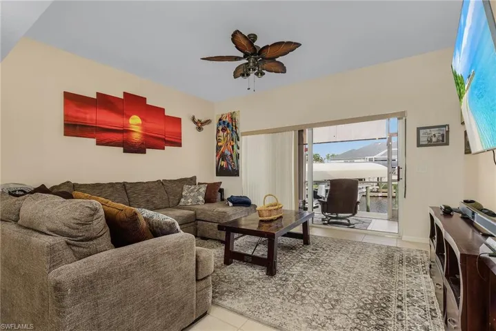 Tiled living room featuring ceiling fan