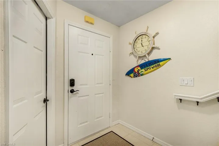 Doorway featuring tile patterned flooring