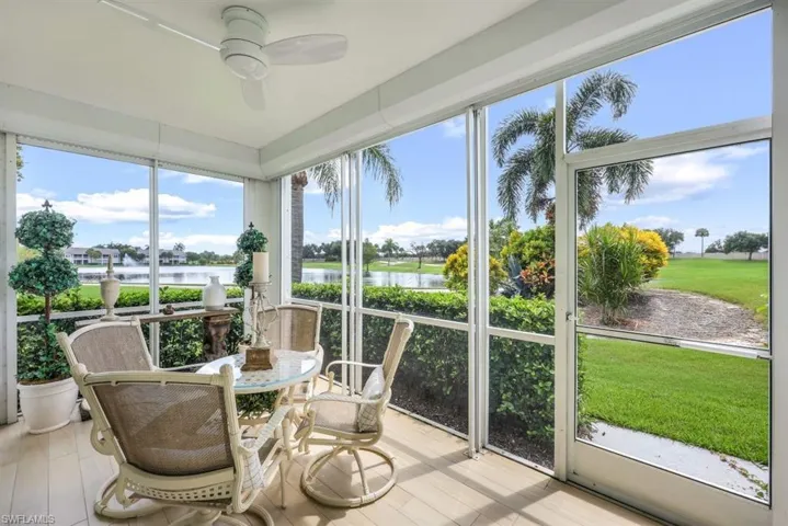 Sunroom / solarium with a water view and ceiling fan