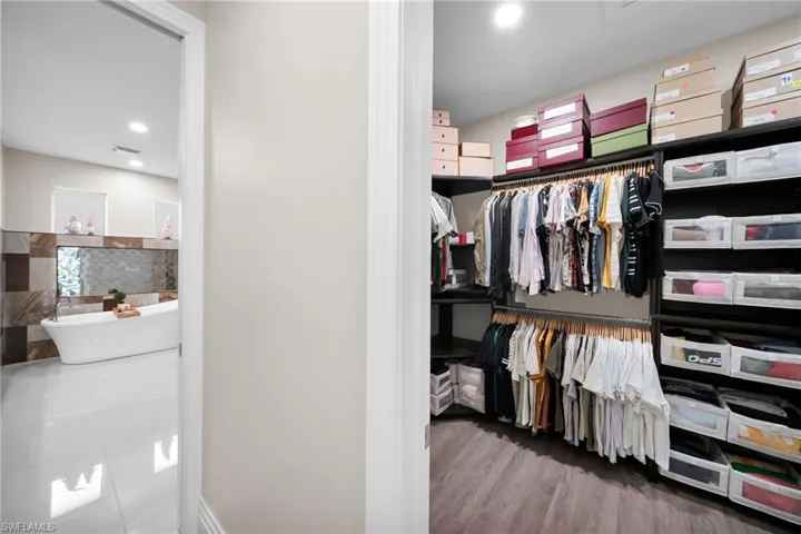 Spacious closet featuring light wood-style flooring