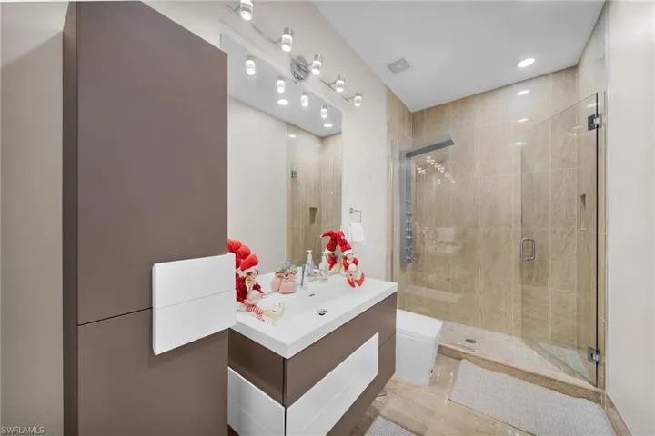Bathroom featuring vanity, a stall shower, and recessed lighting