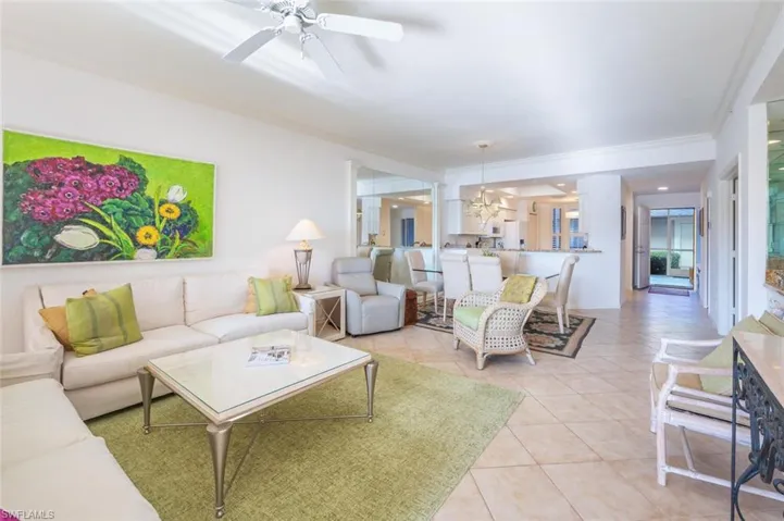 Living area with light tile patterned flooring and a ceiling fan
