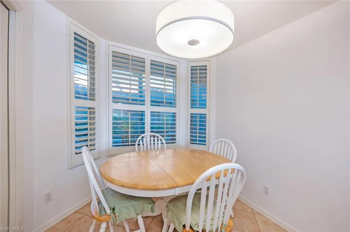 Dining room with light tile patterned floors and baseboards