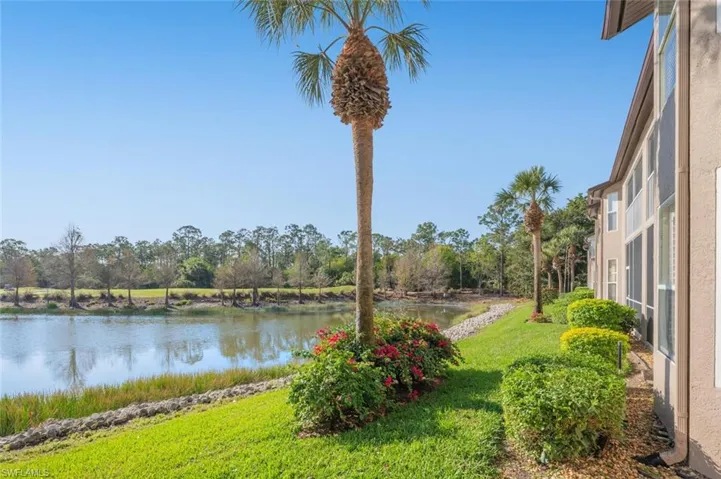 View of green lawn featuring a water view