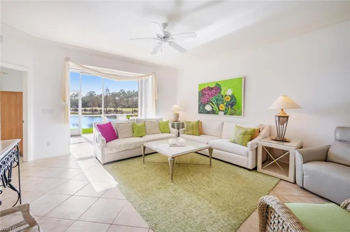 Living room featuring light tile patterned flooring and a ceiling fan