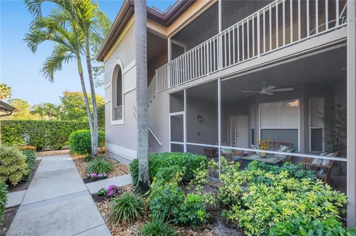 View of side of home featuring stucco siding, a ceiling fan, a balcony, and a sunroom