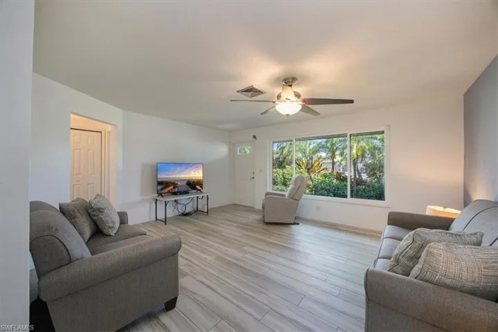 Living room impact windows and luxury vinyl flooring.