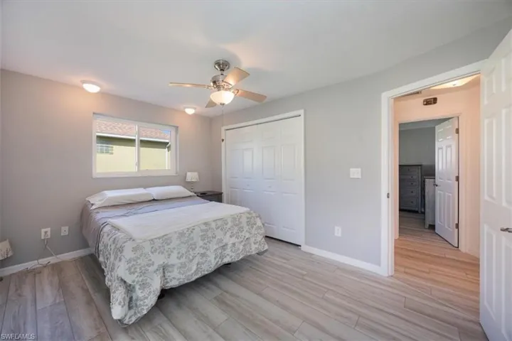 Master bedroom with storm windows and luxury vinyl flooring.