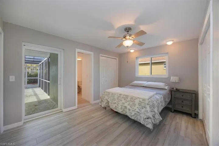 Master bedroom featuring slider to the pool area, and luxury vinyl flooring.