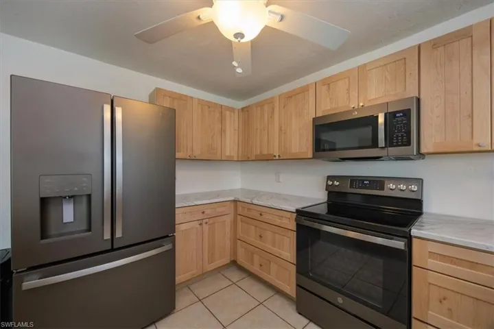 Kitchen featuring new appliances and cabinets.