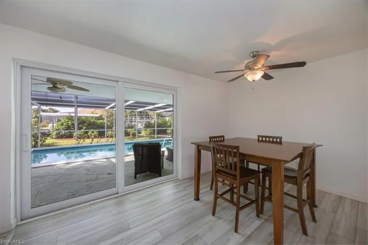 Dining room with impact sliding doors that lead to the pool.