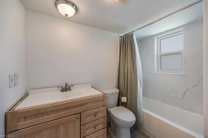 Master bathroom featuring new tiled shower and tub.