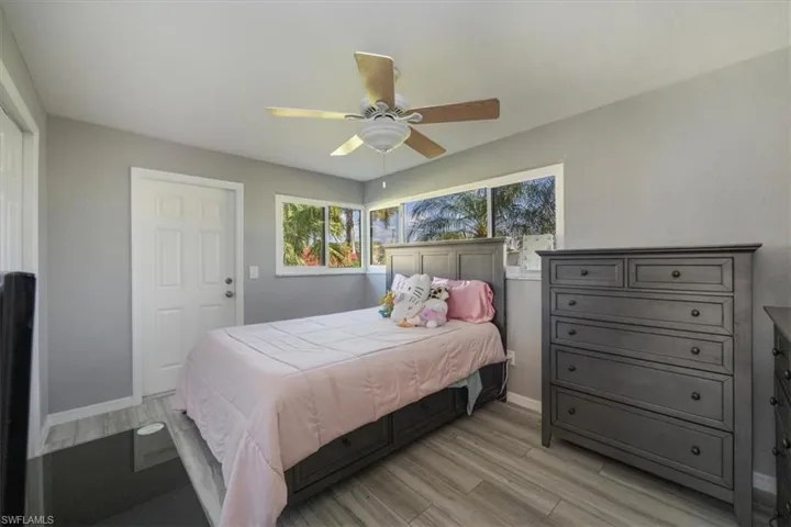 Guest bedroom with impact windows and luxury vinyl tile.
