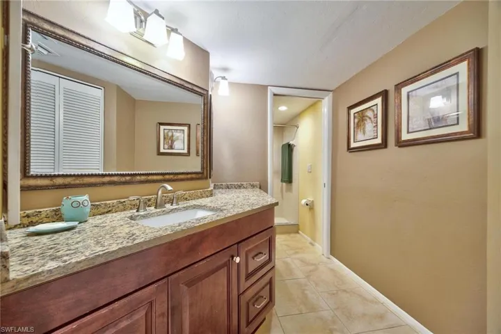 Bathroom with vanity and light tile patterned flooring