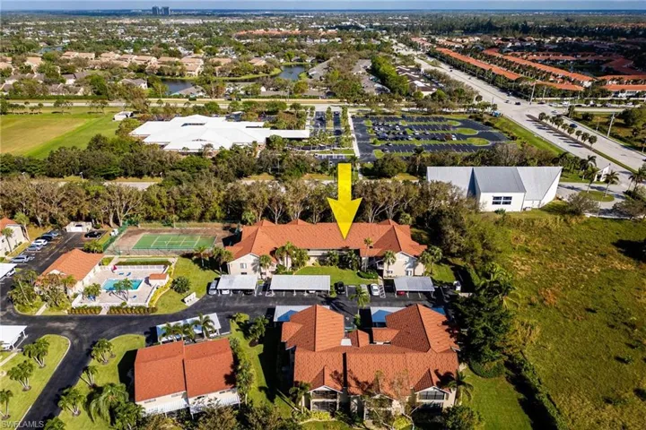 Aerial view of property's location with nearby suburban area and a large body of water