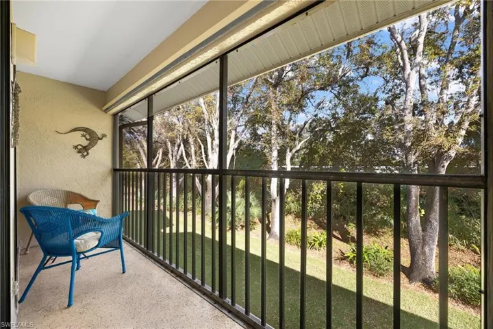 Unfurnished sunroom with view of scattered trees