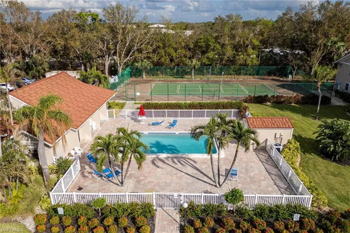 Bird's eye view of a pool area and a tree filled landscape