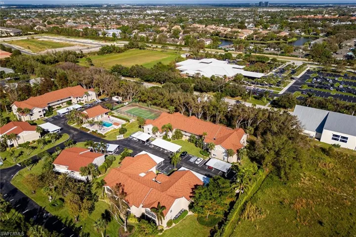 Aerial view of property and surrounding area with nearby suburban area and a nearby body of water