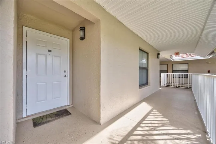 Entrance to property with stucco siding