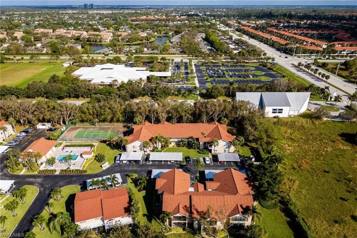 Aerial view of property and surrounding area featuring nearby suburban area