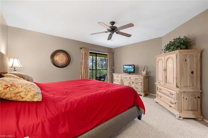 Bedroom featuring carpet, access to exterior, and ceiling fan