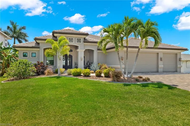 View of front of property featuring a garage and a front yard