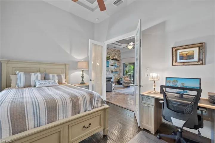 Bedroom featuring a high ceiling, dark hardwood / wood-style floors, and ceiling fan