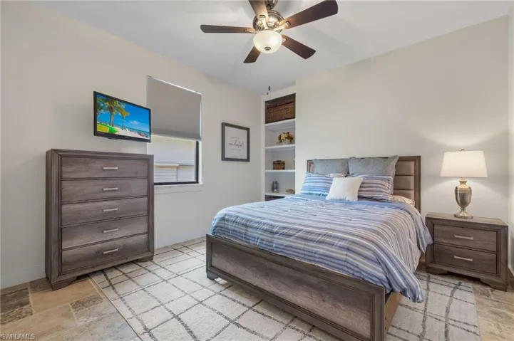 Bedroom featuring ceiling fan and light tile floors