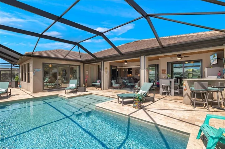 View of pool with a patio, a lanai, and ceiling fan