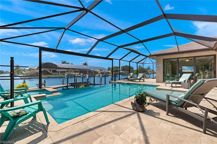View of pool featuring a patio, a lanai, and a water view