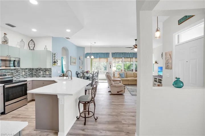 Kitchen with sink, a kitchen breakfast bar, tasteful backsplash, kitchen peninsula, and appliances with stainless steel finishes