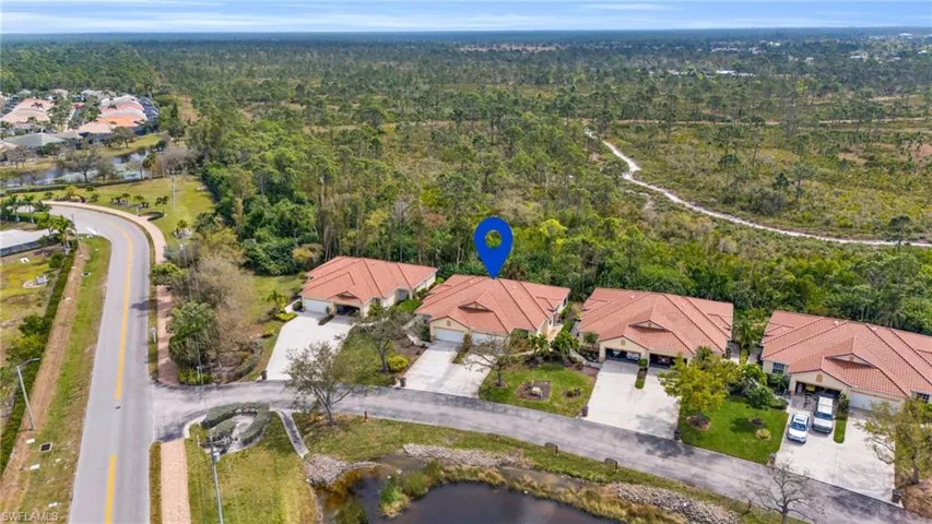 Birds eye view of property with a water view