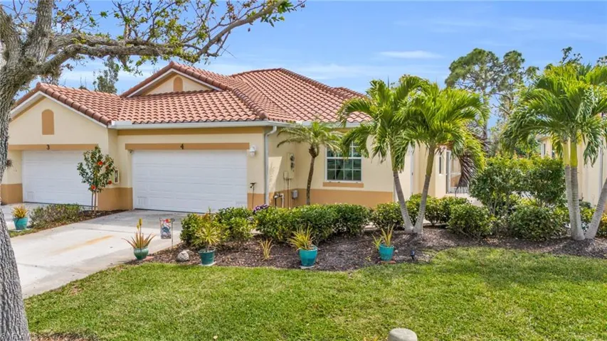 Mediterranean / spanish home featuring a garage and a front yard