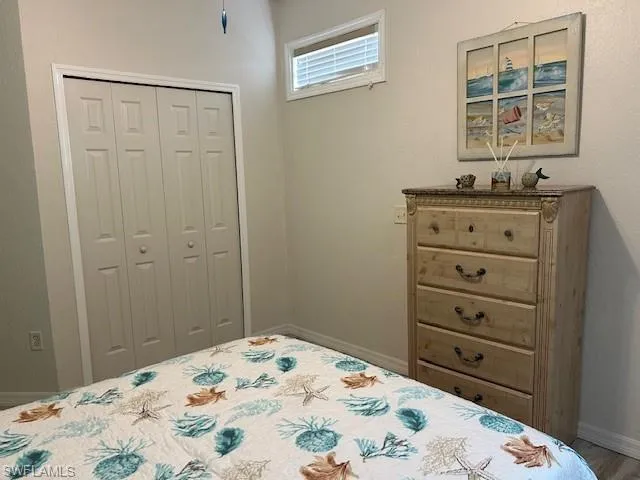 Bedroom with wood-type flooring and a closet