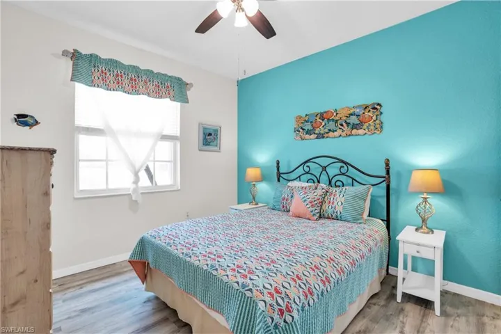 Bedroom featuring ceiling fan and wood-type flooring