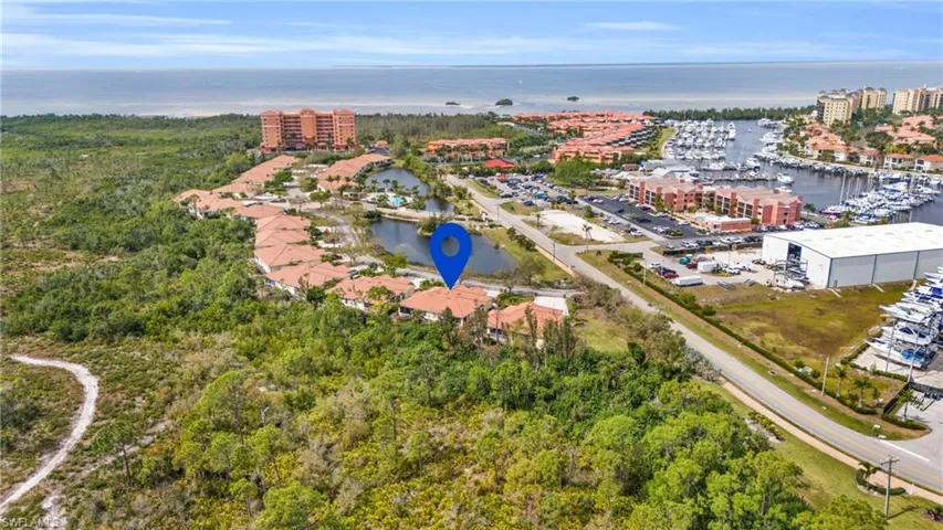 Birds eye view of property with a water view