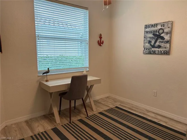 Office space featuring ceiling fan and light wood-type flooring