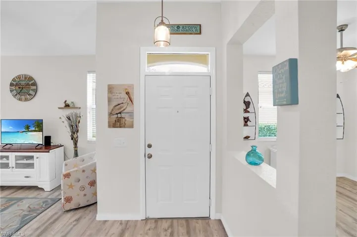 Entrance foyer with light hardwood / wood-style flooring
