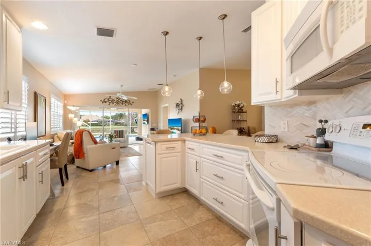 15366 Upwind Dr Bonita Springs FL 34135 - Opened kitchen layout with easy drawer access to lower cabinets.