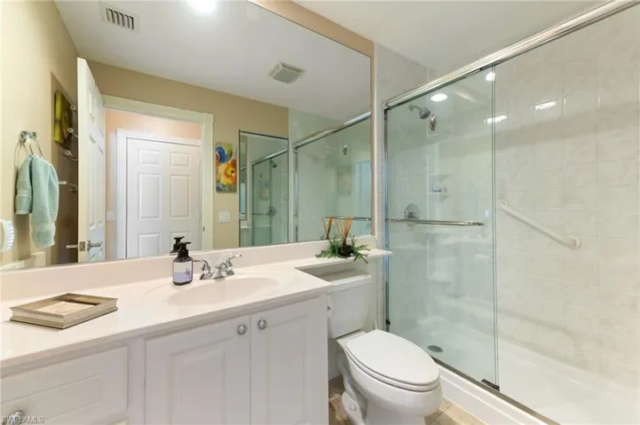 15366 Upwind Dr Bonita Springs FL 34135 - Bathroom 2 with glass shower doors and under vanity lighting.