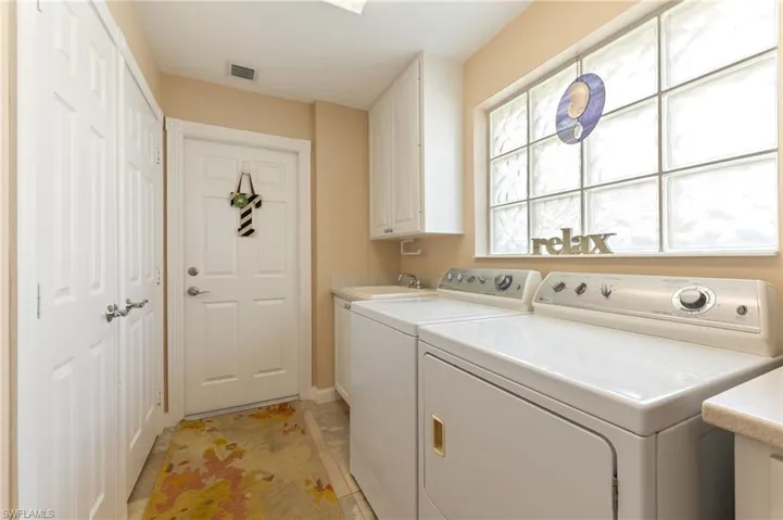 15366 Upwind Dr Bonita Springs FL 34135 - Laundry room with utility sink and entry from garage