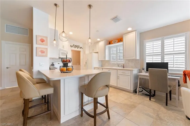 15366 Upwind Dr Bonita Springs FL 34135 - Breakfast bar with lower cabinet access from outside.