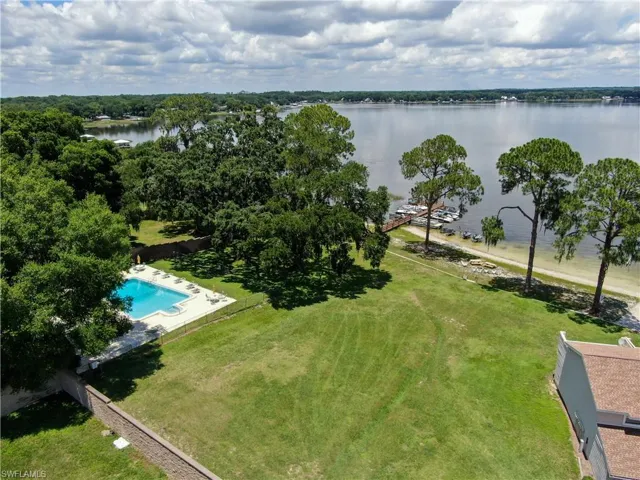 Birds eye view of property with a water view