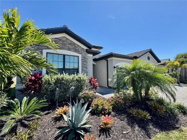 View of front of home featuring stucco siding and stone siding