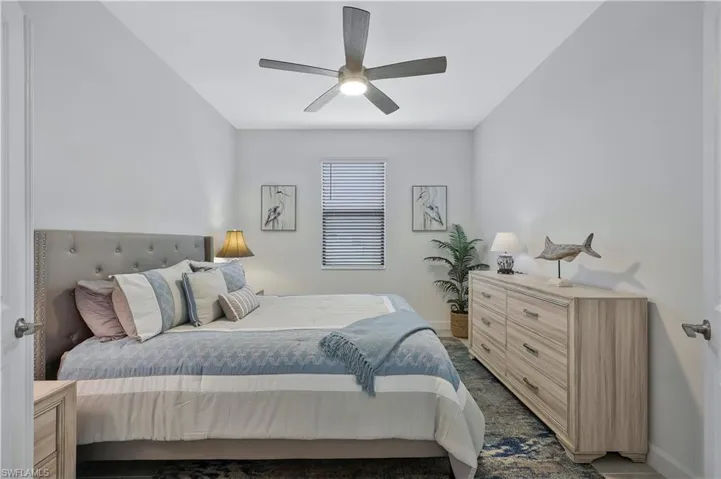 Bedroom featuring a ceiling fan and baseboards