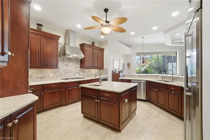 Stunning chef’s kitchen features leathered Quartzite counters, stone backsplash, custom cabinetry, high-end appliances with gas available & adjacent wine room AND butler’s pantry.